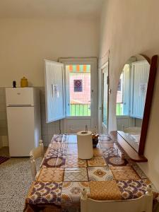 a kitchen with a table with a pattern on it at Ostello moderno centro- cucina Wi-Fi in Livorno