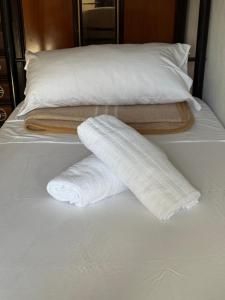 two towels are on top of a bed at Ostello moderno centro- cucina Wi-Fi in Livorno