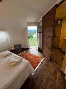 a bedroom with a bed and a door leading to a doorway at Vita Nova Hotel in Olympos