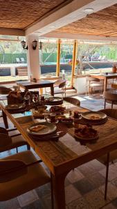 a large wooden table with plates and dishes on it at Vita Nova Hotel in Olympos