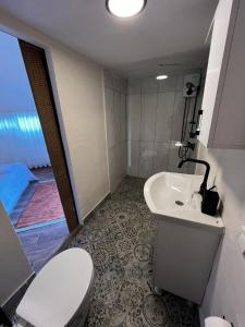 a bathroom with a toilet and a sink at Vita Nova Hotel in Olympos +16 photos