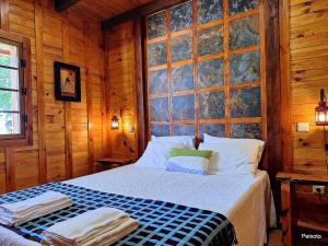 a bedroom with a bed in a wooden cabin at Casa das Devesas in Caldelas +78 photos