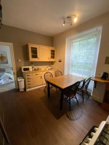 a kitchen with a table and chairs in a room at City Centre Double Room in Truro