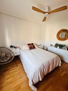 a bedroom with a bed and a ceiling fan at Ático La Puerta de Logroño, con terraza y piscina! in Logroño