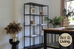 a black shelving unit next to a table at Lux Living No 6 Luxury 1-Bed Free Parking Oxford in Oxford