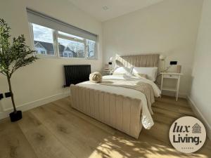 a bedroom with a bed and a large window at Lux Living No 6 Luxury 1-Bed Free Parking Oxford in Oxford