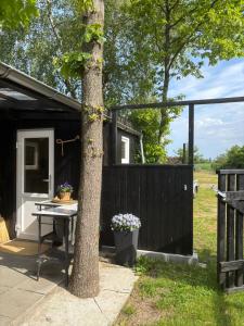 a black shed with a table next to a fence at Bolding Apartments in Billund
