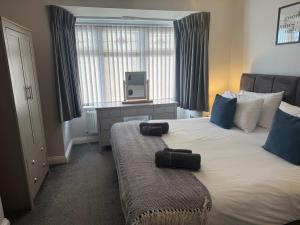 a bedroom with a large bed with a tv on it at The Homestead House in Doncaster