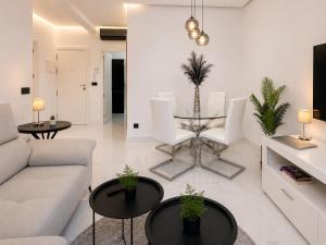 a living room with a couch and a table and chairs at Holibai Antia Mare Centro de Baiona y mar in Baiona