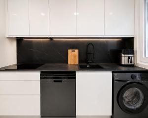 a kitchen counter with a sink and a dishwasher at Holibai Antia Mare Centro de Baiona y mar in Baiona