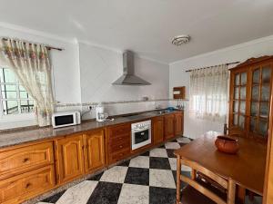 a kitchen with wooden cabinets and a stove top oven at La Casuca del Chiguito in Chipiona