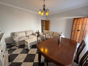 a living room with a table and a couch at La Casuca del Chiguito in Chipiona +5 photos