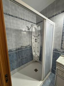 a bathroom with a sink in the corner of a shower at La Casuca del Chiguito in Chipiona