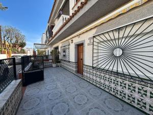a building with a gate and a door on a balcony at La Casuca del Chiguito in Chipiona