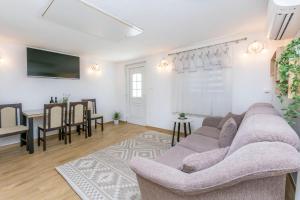 a living room with a couch and a dining room at House Romance for two in Zagvozd