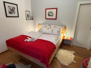 a bedroom with a bed with a stuffed animal on it at Ferienwohnung Wildrose in Bad Mitterndorf