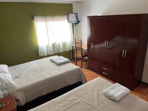 a bedroom with two beds and a dresser and a window at Casa Salkantay Cusco in Cusco +121 photos