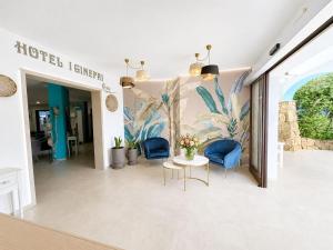 a lobby of a hotel with chairs and a table at I Ginepri Hotel in Cala Gonone +82 photos