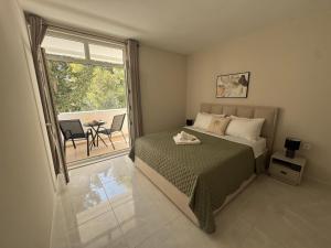 a bedroom with a bed and a table and a window at Illyrian Resort in Milna +262 photos