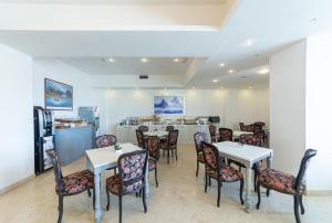 a restaurant with tables and chairs and a counter at Hotel Sakura, Sure Hotel Collection by Best Western in Torre del Greco +40 photos