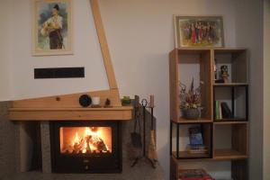 a fireplace in a living room with a fire at Kaba Home - Mountain Villa with Sauna in Stoykite