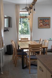 a dining room with a wooden table and chairs at Kaba Home - Mountain Villa with Sauna in Stoykite