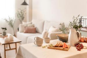 a living room with a table with a plate of food at CASA CALMA Isla Tabarca - Alicante in Tabarca