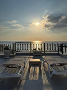 a patio with two chairs and a table on a balcony at Prestige Lux Apartment in Bijela Glavica