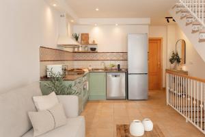 a kitchen with a refrigerator freezer in a room at CASA CALMA Isla Tabarca - Alicante in Tabarca