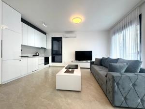 a living room with a couch and a table at Prestige Lux Apartment in Bijela Glavica