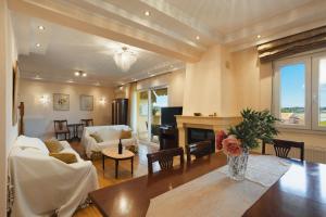 a living room with a table and a fireplace at Maisonette ELINA in Corfu