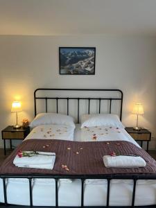 a bedroom with two beds with towels on them at Harderkulm in Interlaken