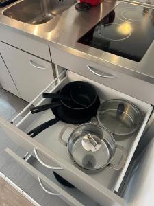 a stove with pots and pans in a kitchen at Harderkulm in Interlaken +4 photos