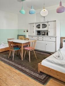a kitchen with a table and chairs in a room at Landhaus Schönblick in Bad Kohlgrub