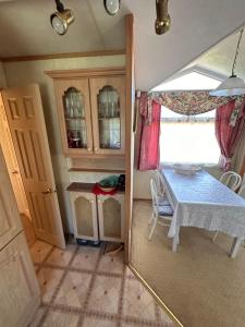 a small kitchen with a table in a room at Английский домик in Lapmežciems
