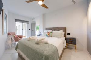 a bedroom with a bed and a ceiling fan at Casa Victoria · Golf, Sun and Sea Breeze. Mojácar in Mojácar +18 photos
