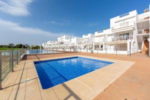 a swimming pool in front of a building at Casa Victoria · Golf, Sun and Sea Breeze. Mojácar in Mojácar