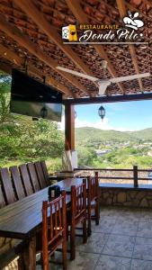 a dining room with a table and chairs and a large window at Hotel y Restaurante Donde Pilo in Santa Rita