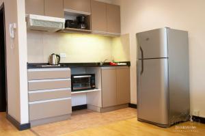 a kitchen with a stainless steel refrigerator at Departamentos - Belgrano 810 in San Martín de los Andes +28 photos
