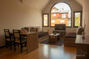 a living room with a couch and a table at Departamentos - Belgrano 810 in San Martín de los Andes
