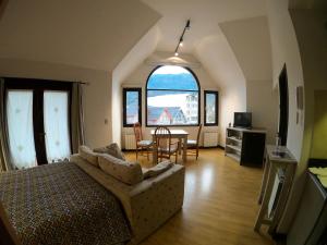 a living room with a bed and a table and chairs at Departamentos - Belgrano 810 in San Martín de los Andes