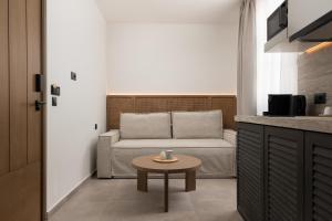 a living room with a couch and a table at Karavel Suites - Old Town in Rhodes Town