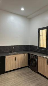 a kitchen with a sink and a washing machine at Villa Princess Goofy in Lomé