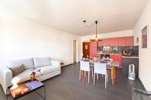 a living room with a white couch and a table at Malibu46 - Minusio Apt with Shared Pool & Balcony - Happy Rentals in Minusio