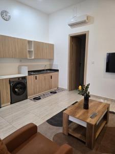 a living room with a table and a kitchen at Villa Princess Goofy in Lomé +44 photos