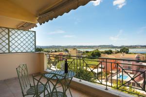 a balcony with chairs and a table and a view at Maisonette ELINA in Corfu