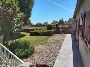 a garden next to a house with a fence at Gite du Fourbas in Belmont-Sainte-Foi +5 photos