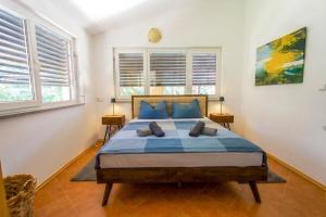 a bedroom with a bed with two pillows on it at Casa Oliva Kim Marie /w Garden - Happy Rentals in Medulin