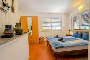 a bedroom with a bed with blue sheets and blue pillows at Casa Oliva Kim Marie /w Garden - Happy Rentals in Medulin