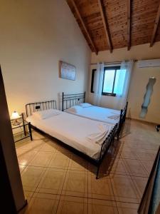 a bedroom with two beds and a window at Jannis Castle Apartment in Himare
